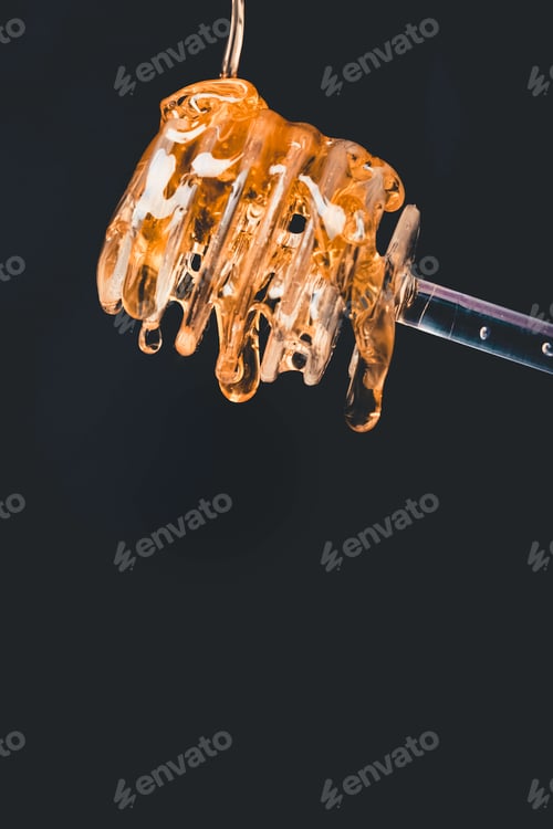 Preview: Close-up of honey dripping from the honey spoon.