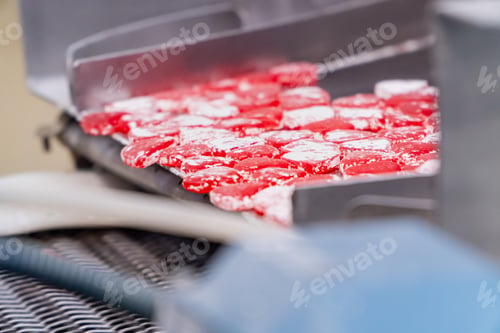 Preview: Red gummy hearts industrial manufacturing on the candy prodution line of a factory