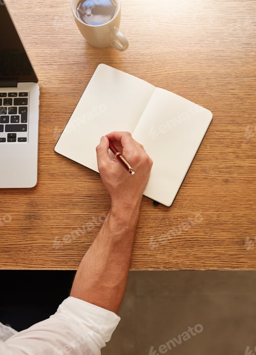 Preview: Man making some notes at his workplace