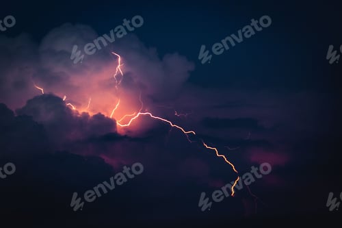 Preview: Dramatic sky with illuminated clouds by a lightning strike over a cityscape at night