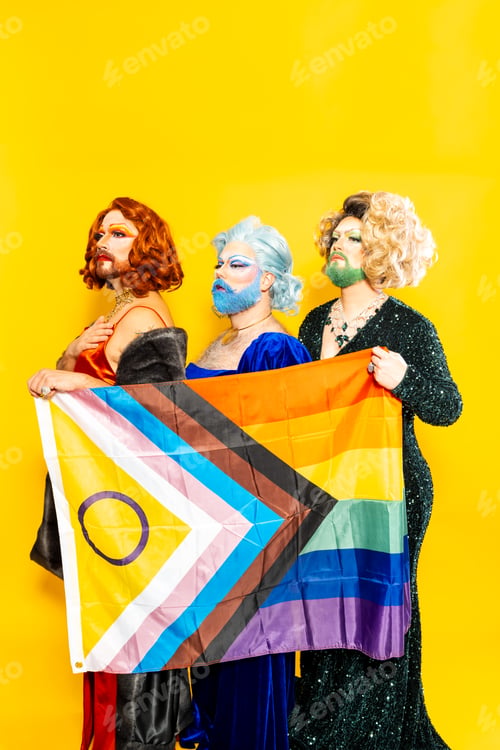Preview: Drag queens standing together with Pride flag