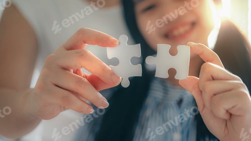 Preview: Happy family, Asian daughter playing jigsaw puzzle with her mother for family concept