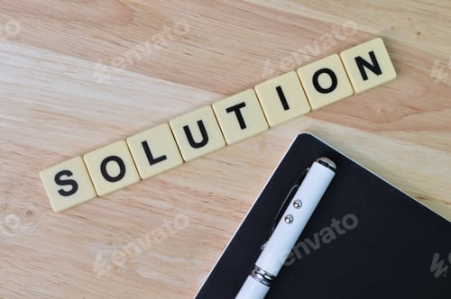 Preview: Square letters with text SOLUTION over wooden background.
