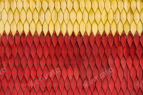 Preview: Old weathered wooden wall with ornament painted in red and yellow. Vintage texture Background.