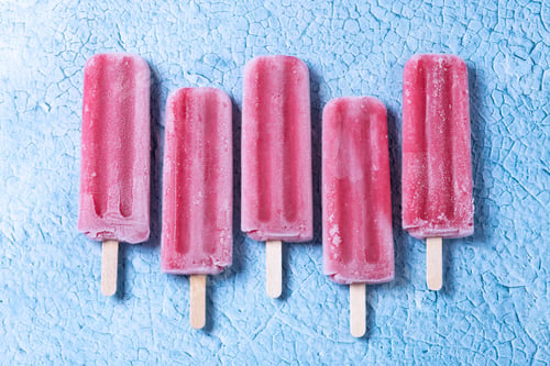 Preview: Strawberry popsicles on blue background