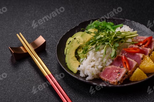 Preview: Seared tuna tataki in a bowl with sesame seeds, rice, and vegetables. Tuna tataki