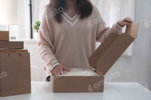 Preview: Women opening, wrapping package box for online shopping, buying, selling concept