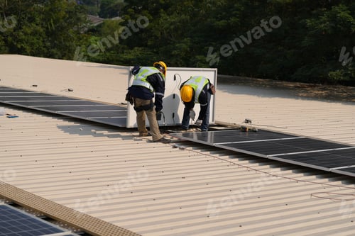 Preview: Engineer installing solar cell panels on roof.