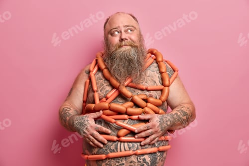 Preview: Food addiction and bad nutrition concept. Plump bearded man stands wrapped in sausages has big fat a