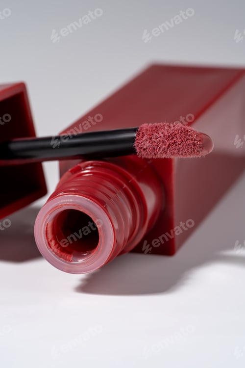 Preview: Closeup Of Red-Pink Lip gloss With Applicator In A Luxury square Bottle For Fashion Makeup