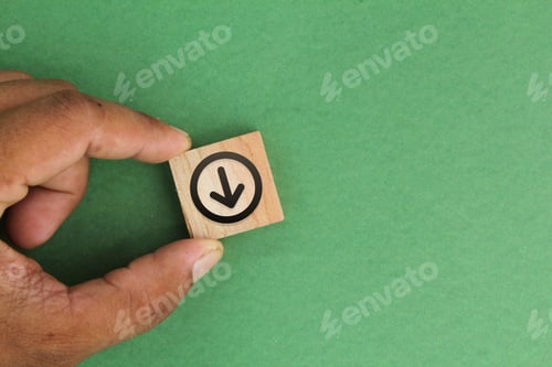Preview: finger holding wooden square with download icon.