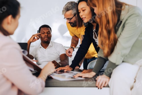 Preview: African american male boss listening to his diverse colleagues during a meeting