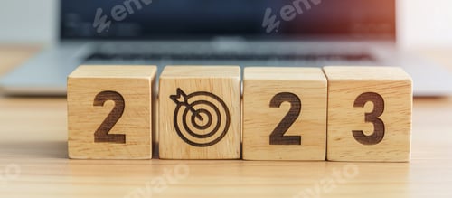 Preview: 2023 Year block with dartboard icon against computer laptop background.
