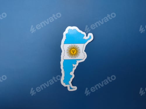 Preview: Top view Argentina flag sticker on a blue background.