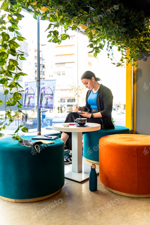 Preview: Designer working with a tablet at coffee shop