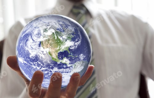 Preview: Businessman holding the world in one hand.