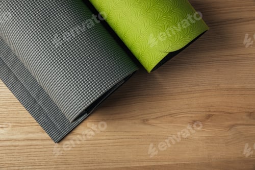Preview: top view of two green and grey yoga mats on wooden floor
