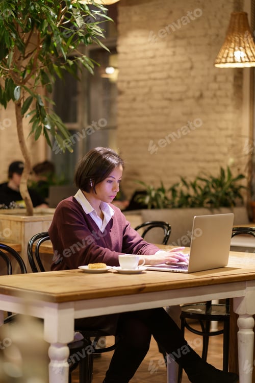 Preview: Serious busy afro female writer or journalist work in cafe use laptop and wifi internet connection