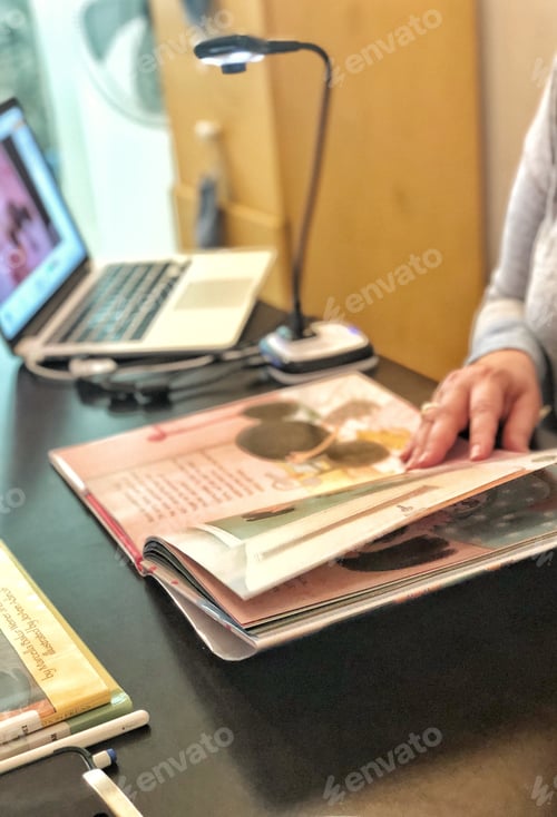 Preview: Remote teaching learning. Woman librarian works from home reading award winning literature remotely