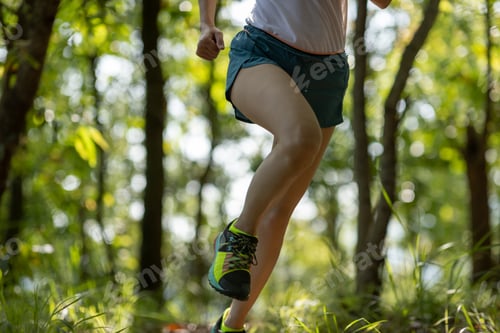 Preview: Woman runner running on forest trail