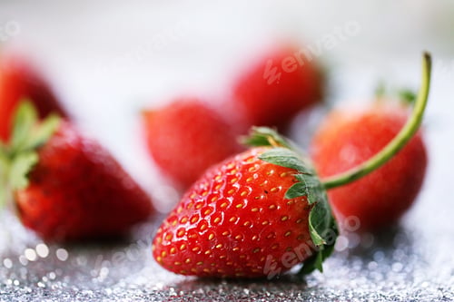 Preview: Closeup macro of fresh red strawberry fruit closeup silver glitter blur background