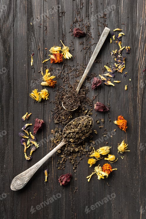 Preview: Dry green and black tea, flower tea on a dark background top view.