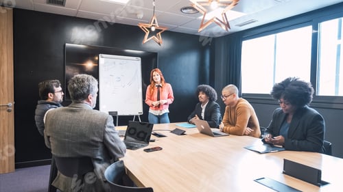 Preview: Businesswoman giving presentation to diverse colleagues in conference room