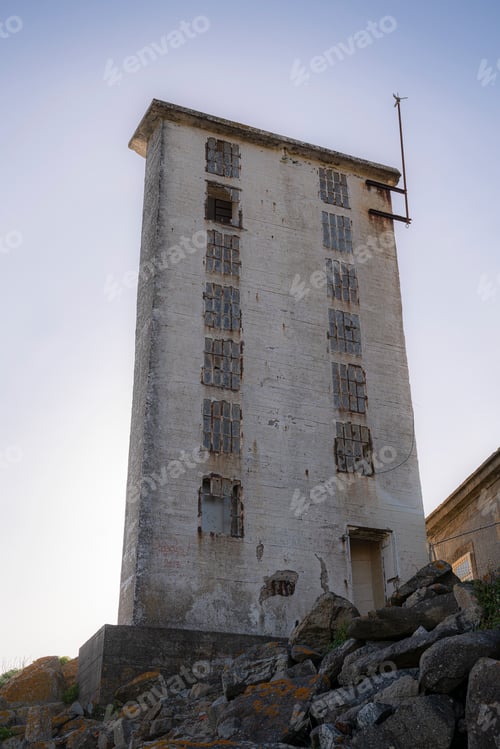 Preview: Vertical shot of an old abandoned electrical transformer
