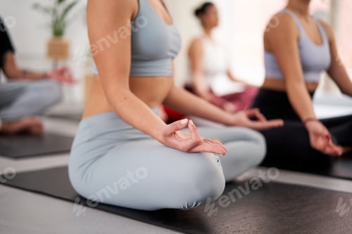 Preview: Unrecognisable woman in yoga class sitting in Sukhasana posture with mudra gesture to meditate.