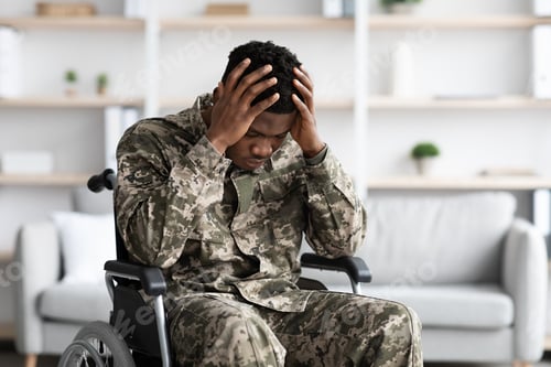 Preview: Upset black man sitting in wheelchair, wearing military uniform