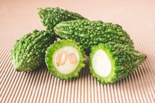 Preview: Bitter melon or bitter gourd on wooden background.