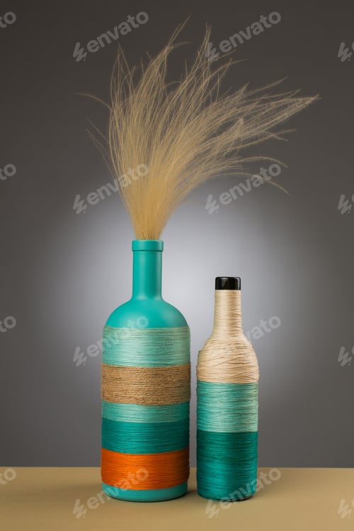 Preview: Decorative Bottles In Studio On Grey Background