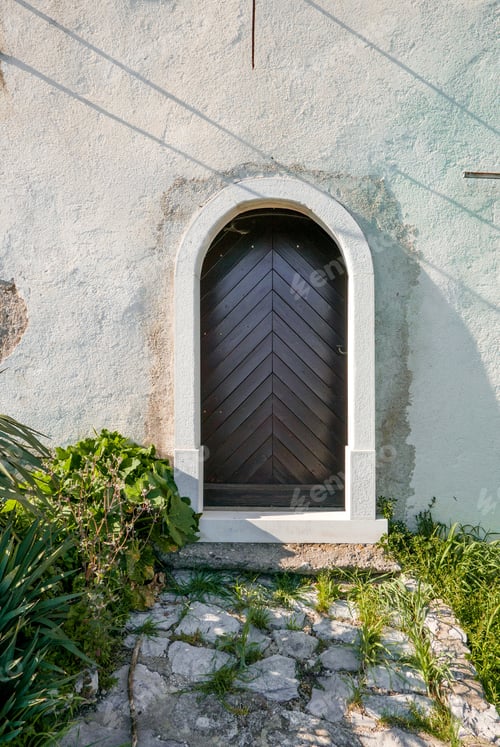 Preview: Minimalist shot of wooden door on an old building.