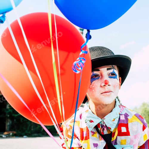 Preview: alone boy 8/6 years old with clown makeup - sad wearing hat and holding ballons