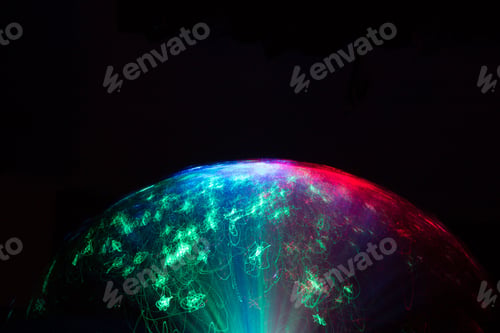 Preview: Closeup shot of a color-changing fibre optic lamp in the darkness, blurred effect in shape of sphere
