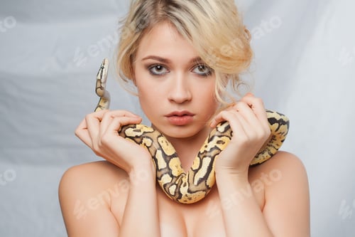 Preview: Beautiful Blonde Girl And Python Around Her Body On Gray Background
