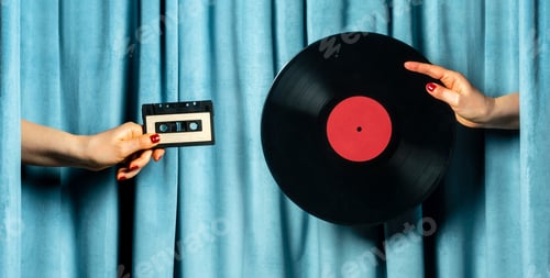 Preview: Female hands with audio tape and vinyl record against blue velvet curtain