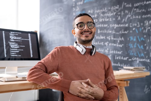 Preview: Young content it-engineer in eyeglasses sitting in front of camera
