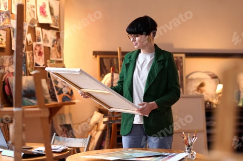 Preview: Female artist holding picture on canvas