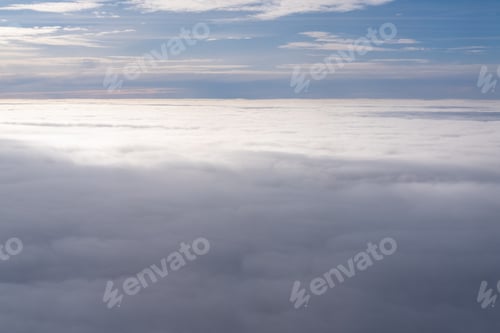 Preview: The view from the plane window of dense curly clouds and blue stratosphere. Blue sky and white cloud