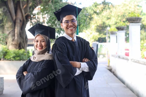 Preview: Confident students in mortarboard and graduation gown standing back to back