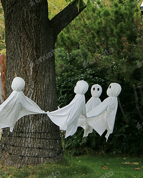 Preview: Halloween yard decoration of ghosts dancing around a tree.