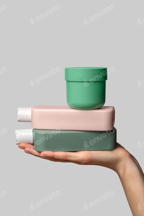 Preview: Woman hand showing set of cream products. Cosmetic product branding mockup.