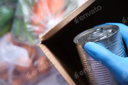 Preview: Door delivery of goods. Order picker packing foods in a cardboard boxes.