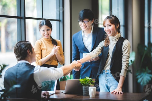 Preview: Business people shaking hands, finishing up a meeting, success concept