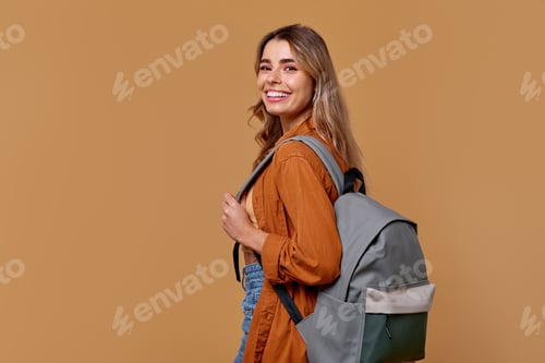 Preview: A Joyful Young Woman with a Stylish Backpack is Smiling Brightly Against a Warm Background