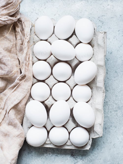 Preview: Overhead view of white eggs in carton