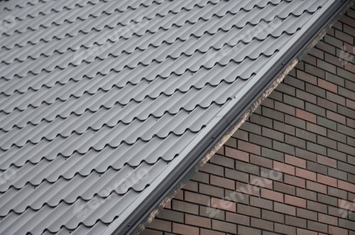 Preview: Modern brown roof made of metal. Corrugated metal roof and metal roofing industry concept