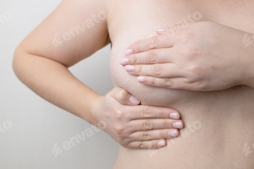 Preview: Caucasian woman chest looking for signs of male breast cancer. Breast examination by herself