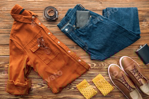 Preview: Flat lay with shirt, jeans and shoes with accessories on wooden background